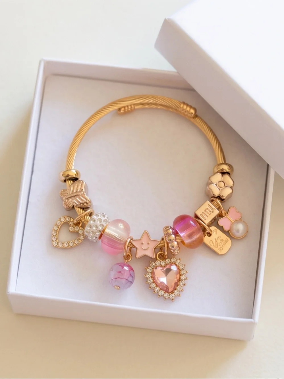 Gold-Tone Pink Charm Bracelet with Heart and Star Accents